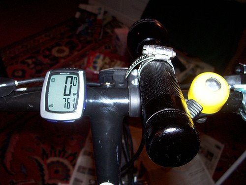 Flashlight attached to flat handlebars with a series of hose clamps.